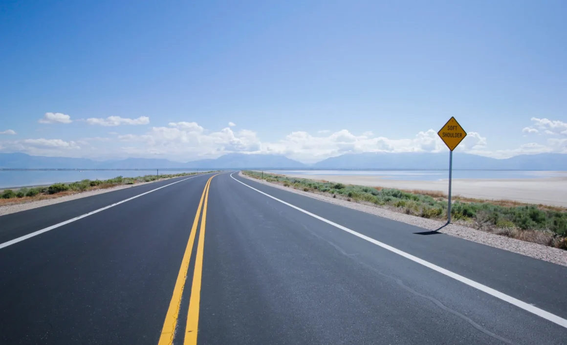 success story open road with mountain view and sign